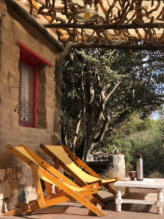 a wooden chair sitting outside of a house at El Rancho Eco Loft in San Javier
