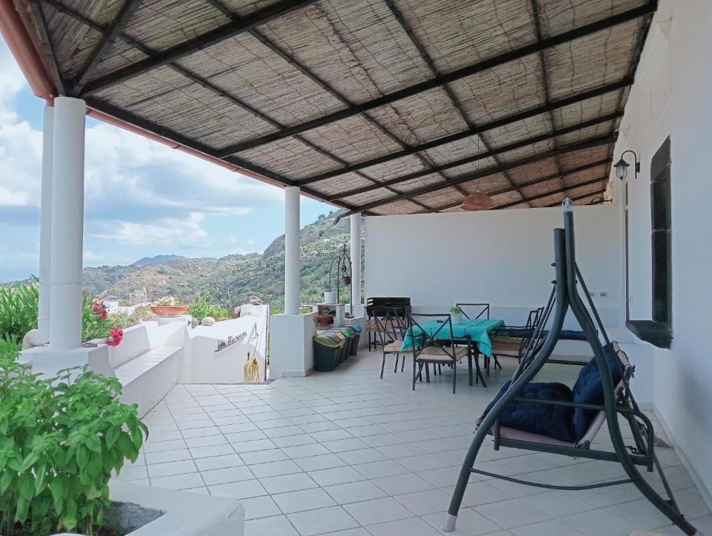 a patio with chairs and a table on a house at Villa MariaRosa in Lipari