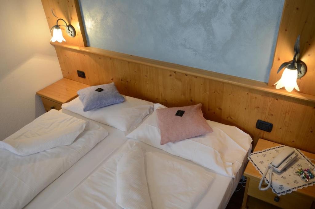 Postel nebo postele na pokoji v ubytování Hotel Corona