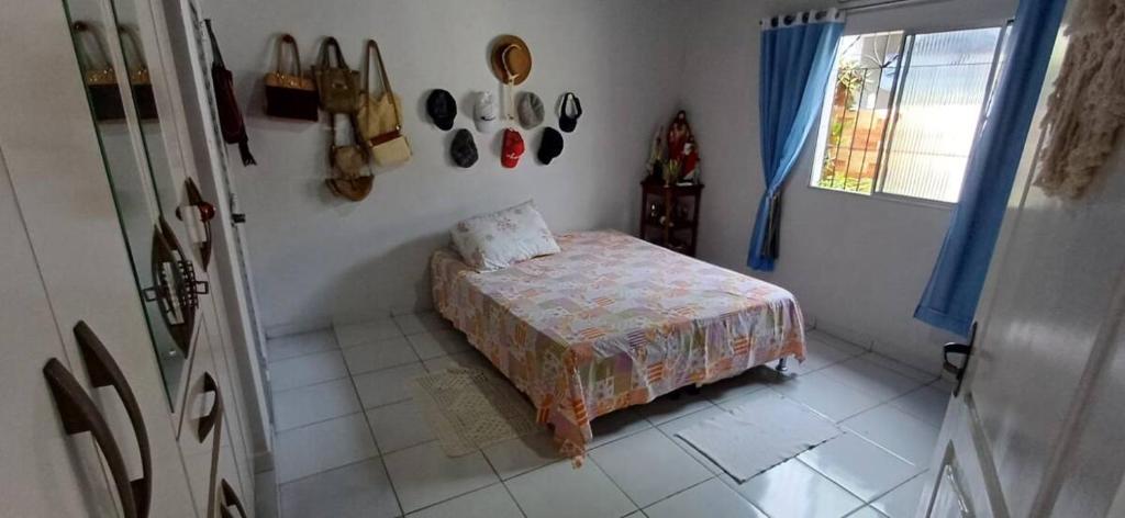 a small bedroom with a bed and a window at Casa na Cidade Nova in Ananindeua