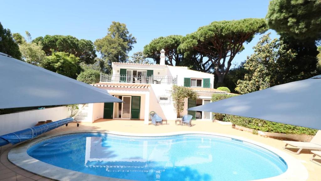 a swimming pool in front of a house at Beautiful Portuguese Villa Casa Das Buganvillas 3 Bedrooms Close To Praca Private Pool Vale Do Lobo in Vale do Lobo