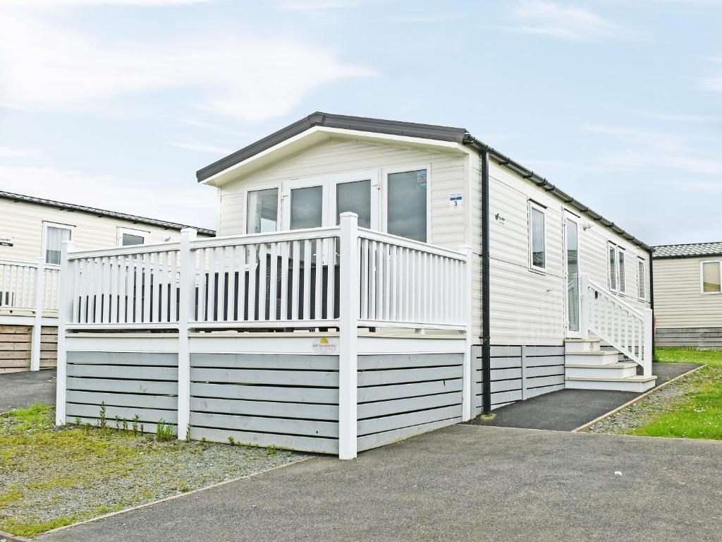 a white house with a white fence at Ocean Edge in Heysham