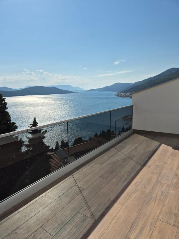a balcony with a view of the water at Hygge-Kuca in Neum