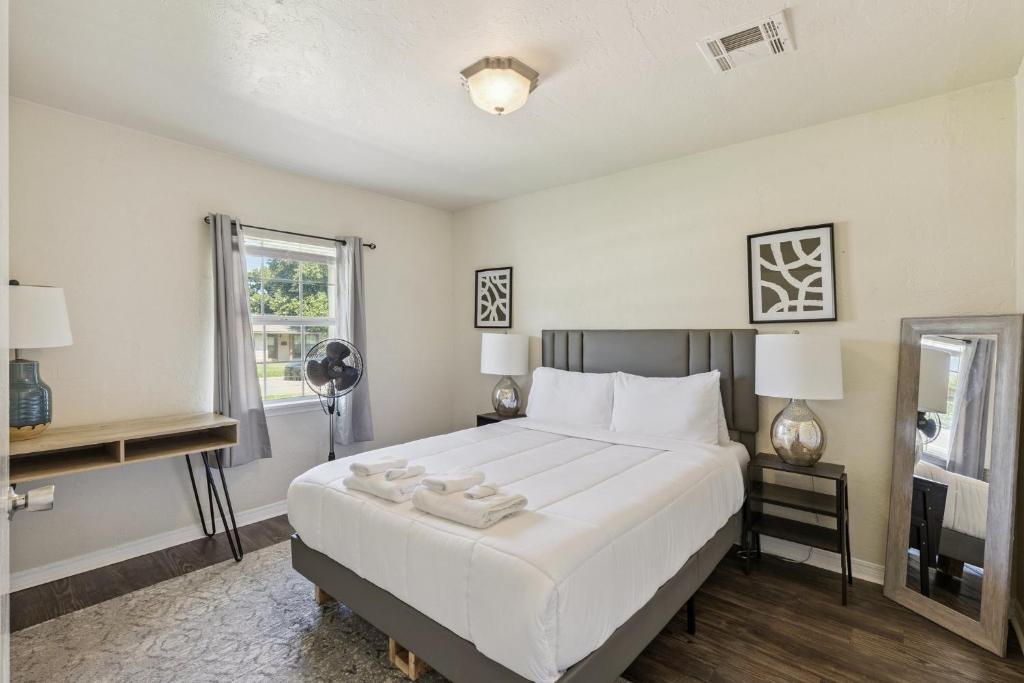 a bedroom with a large white bed and a window at 2br Family Getaway With Wifi Smart Tv #ta in Oklahoma City