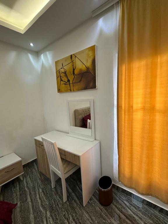 a white desk with a mirror and a painting on the wall at Aberdeen Richview Luxury Apartments Full 1 Bedroom Apartment Sleeps 3 A200 in Freetown