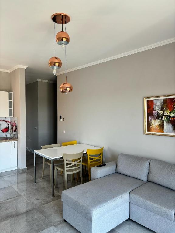 a living room with a couch and a table at Emma's Apartments in Tirana