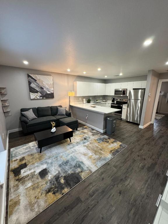 a large living room with a couch and a kitchen at 3 STATE FAIR l DT Dallas l FIFA READY l Staycation 1Bd1Ba in Dallas
