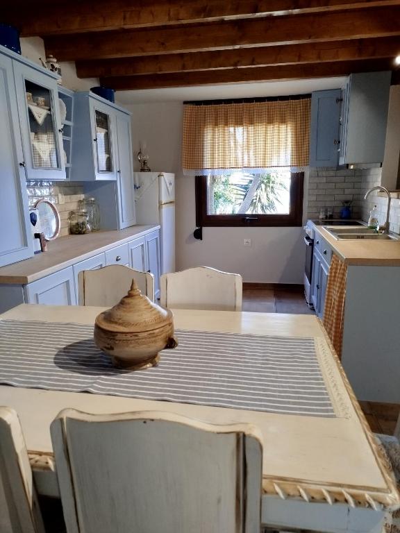 a kitchen with a table with a bowl on it at dilemi 3 in Tavari
