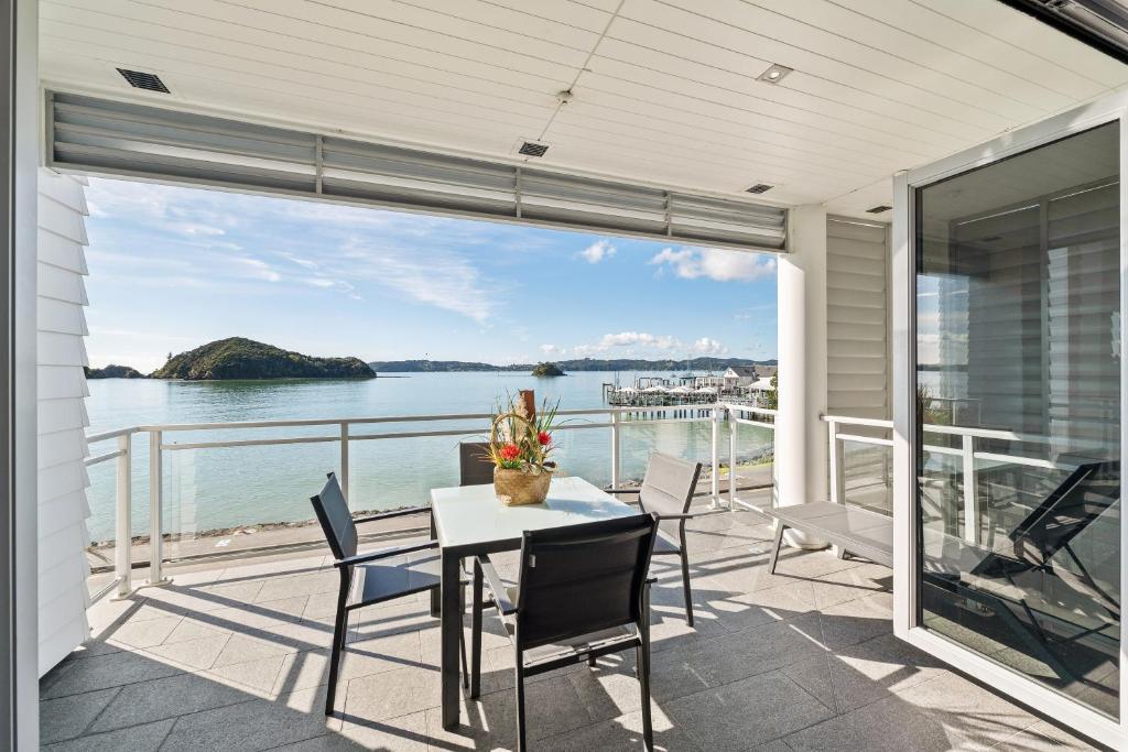 a dining room with a view of the water at Beach Front 2 Bedroom Apartment in Paihia