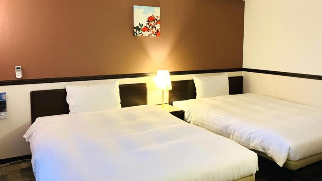 Postel nebo postele na pokoji v ubytování Toyoko Inn Osaka Abeno Tennoji