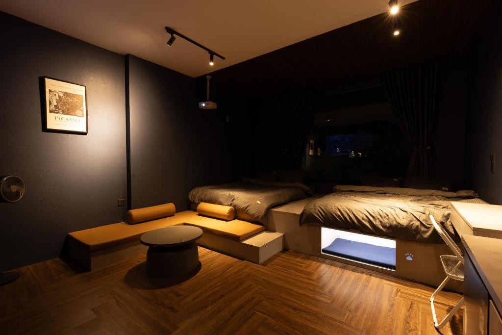 a room with two beds and a stool in it at Midas Home in Da Lat