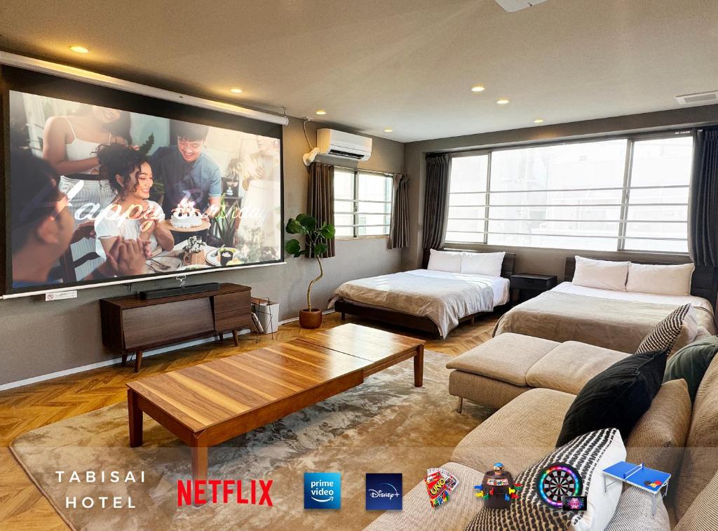 a living room with a large flat screen tv at TABISAI HOTEL Premium 博多-中洲 in Fukuoka