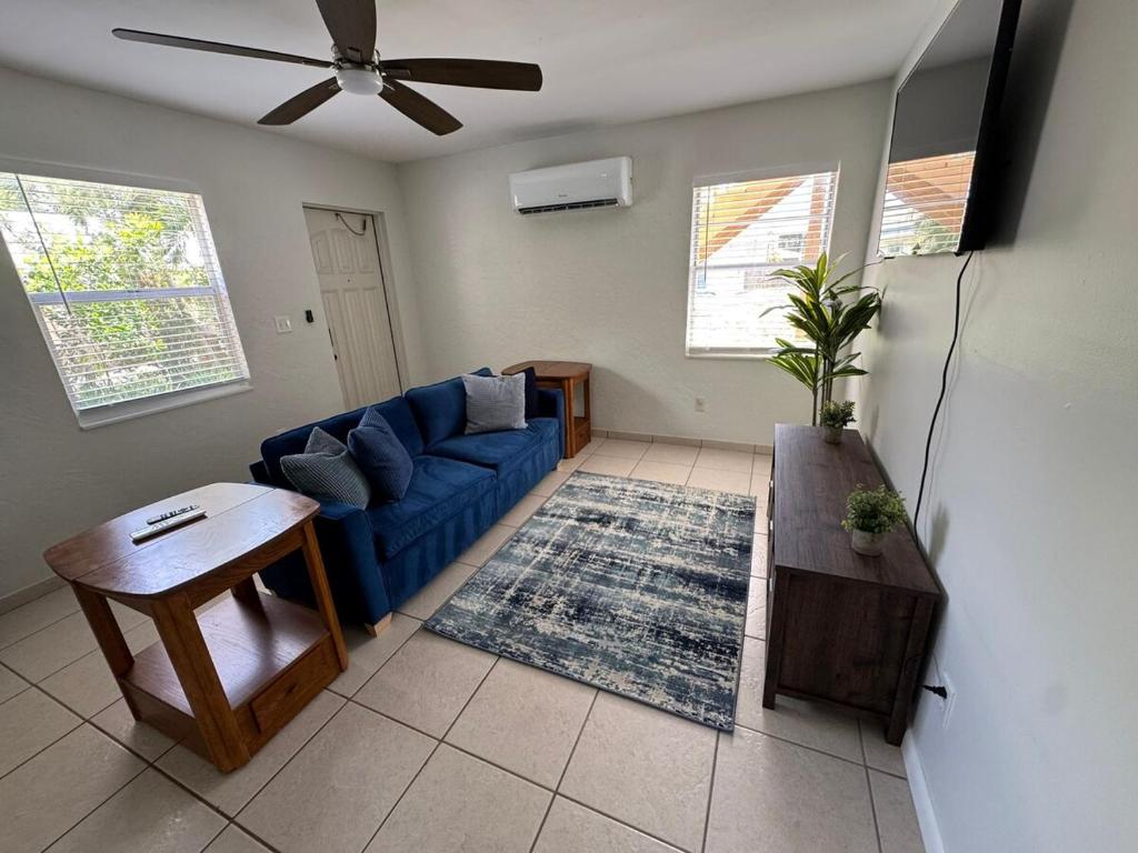 a living room with a blue couch and a table at Apartment in Bonita in Bonita Springs