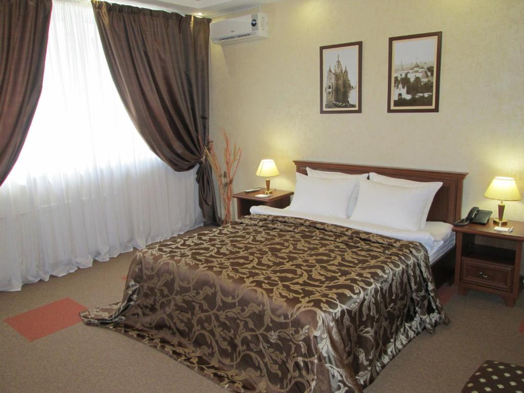 a hotel room with a bed and a window at Avtozavodskaya Hotel in Nizhny Novgorod