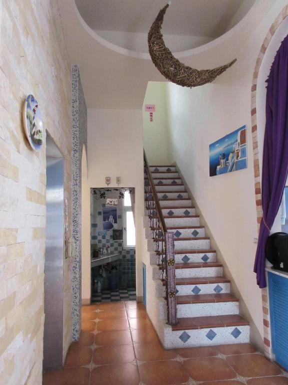 a staircase in a villa with a view of the ocean at Lighthouse B&amp;B in Dahan