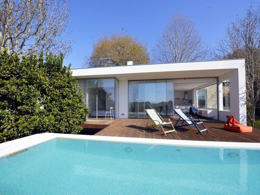 a house with a swimming pool next to a house at Contemporary Caminha Villa 2 Bedrooms Villa Oceanic Escape Private Pool & Uninterrupted Sea Views North Portugal in Caminha