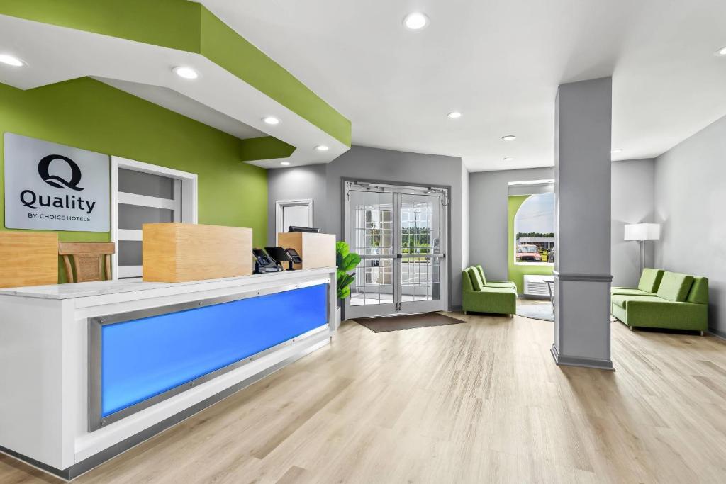 a lobby of a office with a large flat screen tv at Quality Inn Shallotte near Ocean Isle Beach in Shallotte