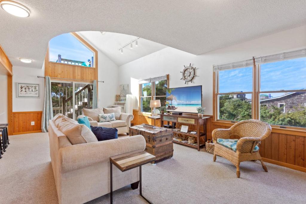 a living room with a couch and a tv at 8074 - Sea Glass Charmer in Avon