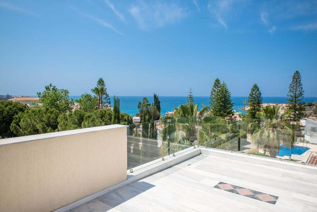 a view of the ocean from the balcony of a house at Coralli Villas in Coral Bay