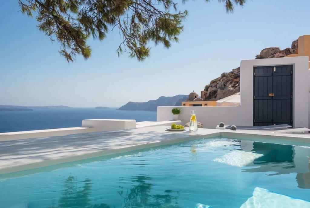 a swimming pool with a view of the ocean at Amazing Santorini Villa 1 Bedroom Pina Caldera Villa Astounding Caldera Views & Private Plunge Pool Oia in Oia