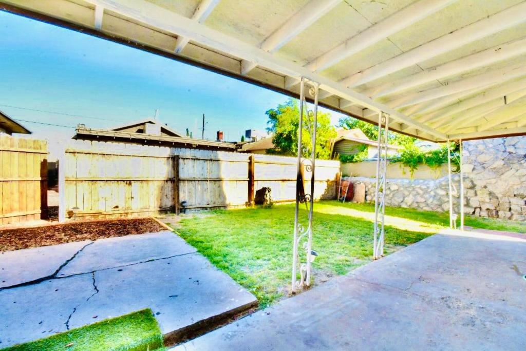 an empty patio with a fence and grass at Entire Home Near Cordova Intl Bridge in El Paso