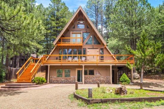a large wooden house with a large deck at Woodland Chalet @ Kachina Village Deck Game Room w Ping Pong Poker Table in Mountainaire