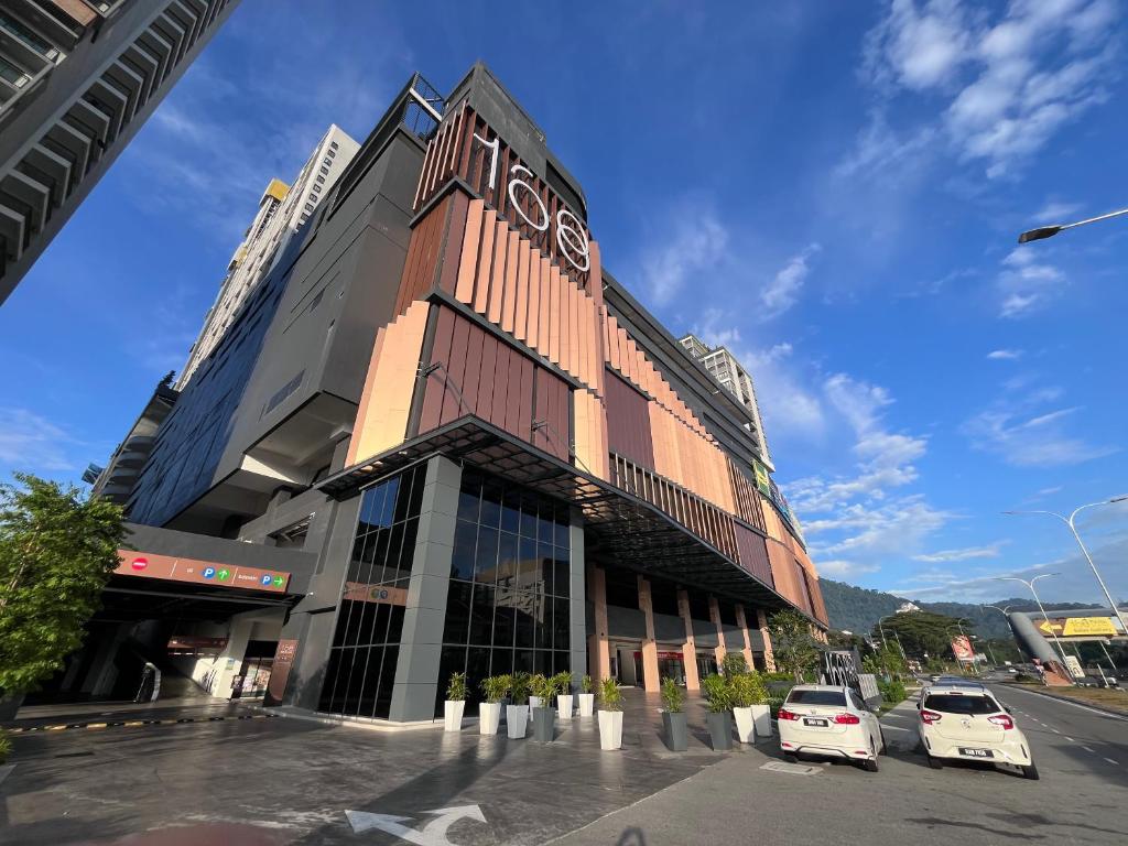 a building with two cars parked in front of it at Pool View Studio - 168 Park Selayang in Batu Caves