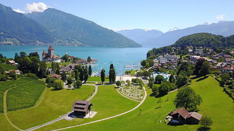 a view of a town with a lake and mountains at BERG & BERG APARTMENTS - Spiez Self-Check-in in Spiez