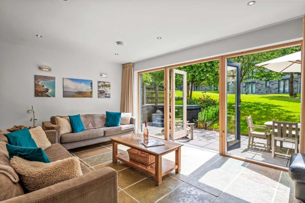 a living room with a couch and a table at House 6 in Looe
