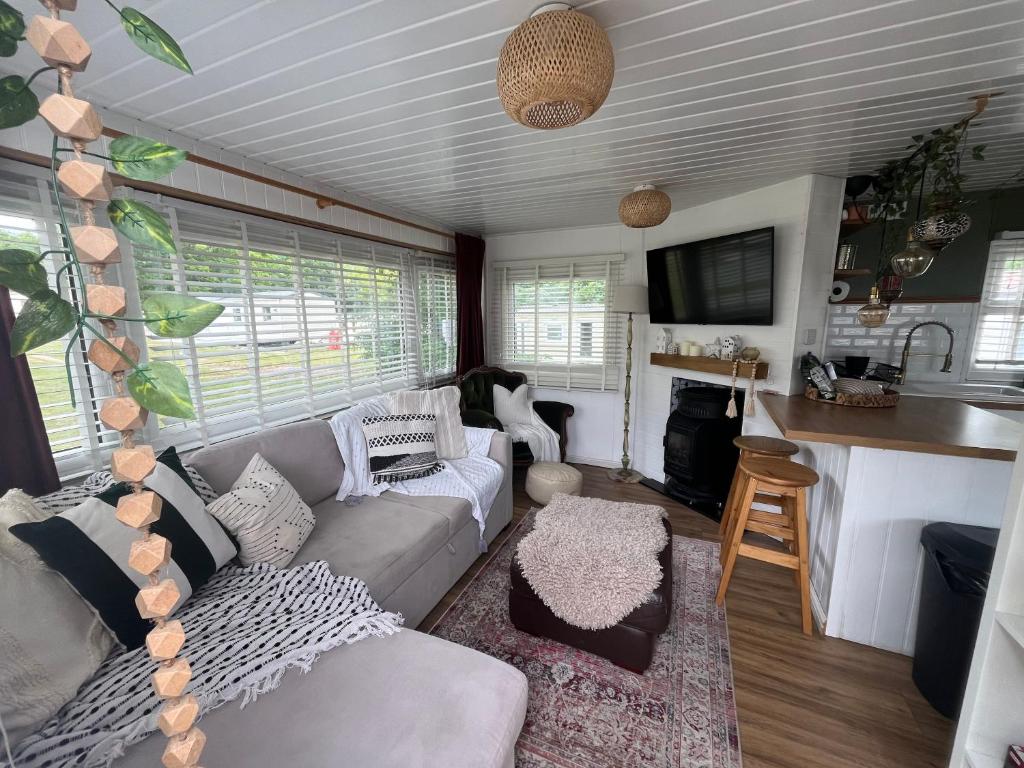 a living room with a couch and a kitchen at The Van in Porchfield
