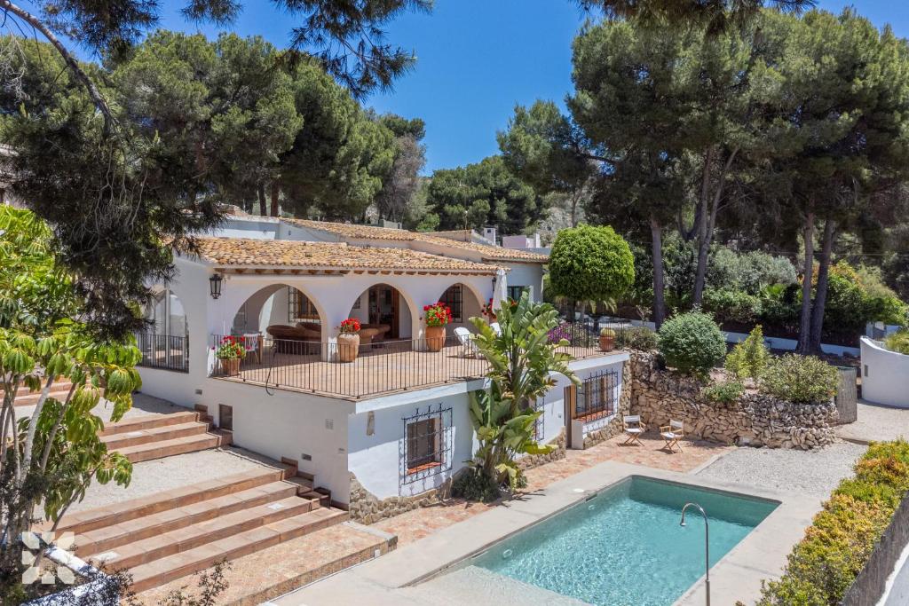 a villa with a swimming pool and trees at Villa Buenos Aires by Abahana Villas in Rada de Moraira