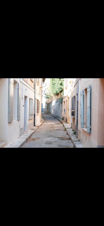 an empty street in an alley between two buildings at Intramuros Avignon House in Avignon