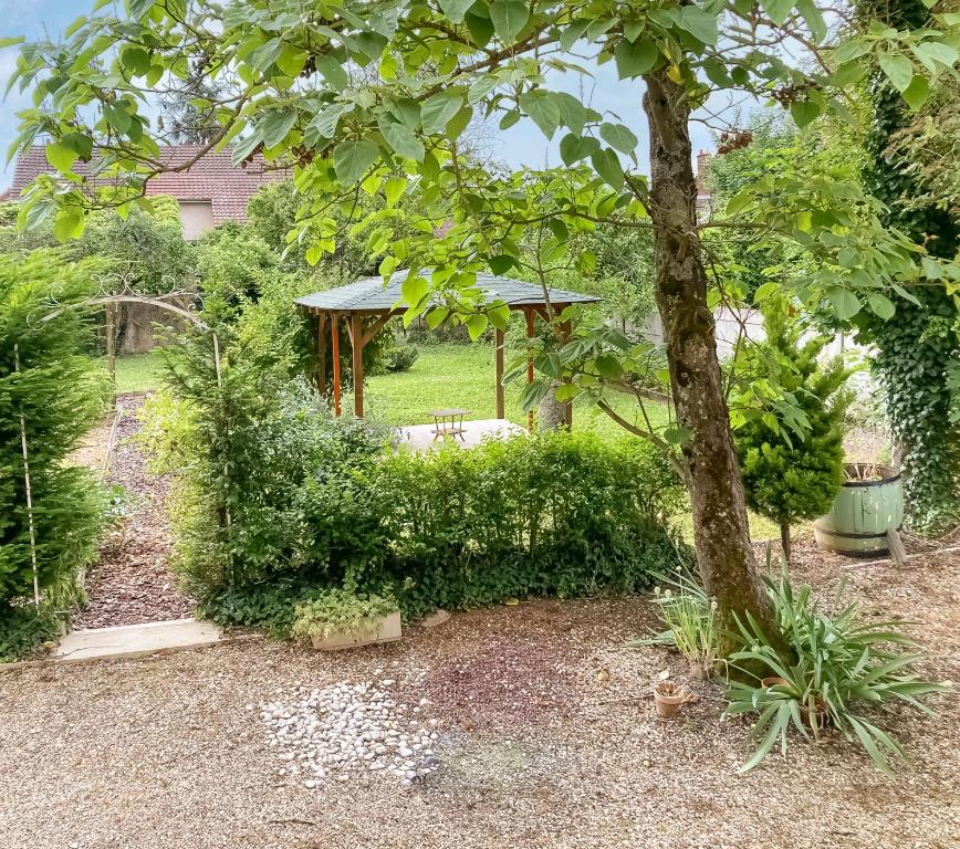 a garden with a tree and a gazebo at Maison cosy avec jardin, 4 chambres, Route du Vin in Nuits-Saint-Georges