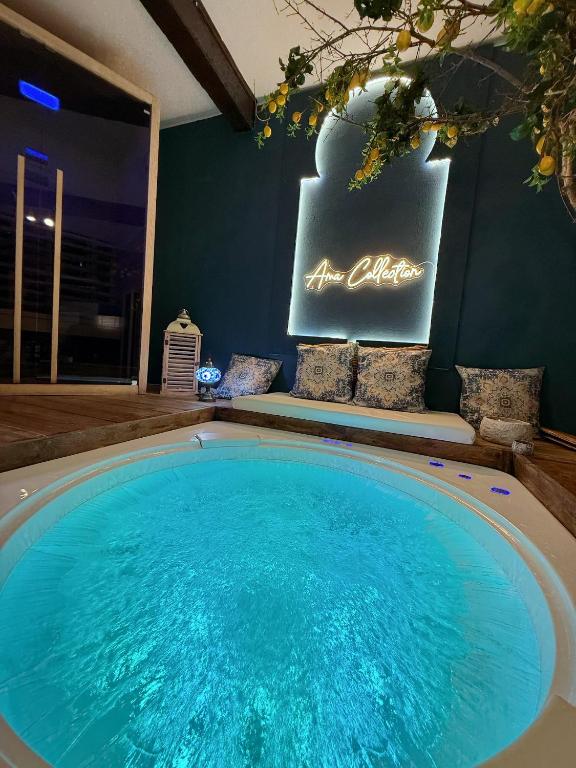 a large swimming pool in a room with a sign at AMA Esclusive SPA Ariosto in Ferrara