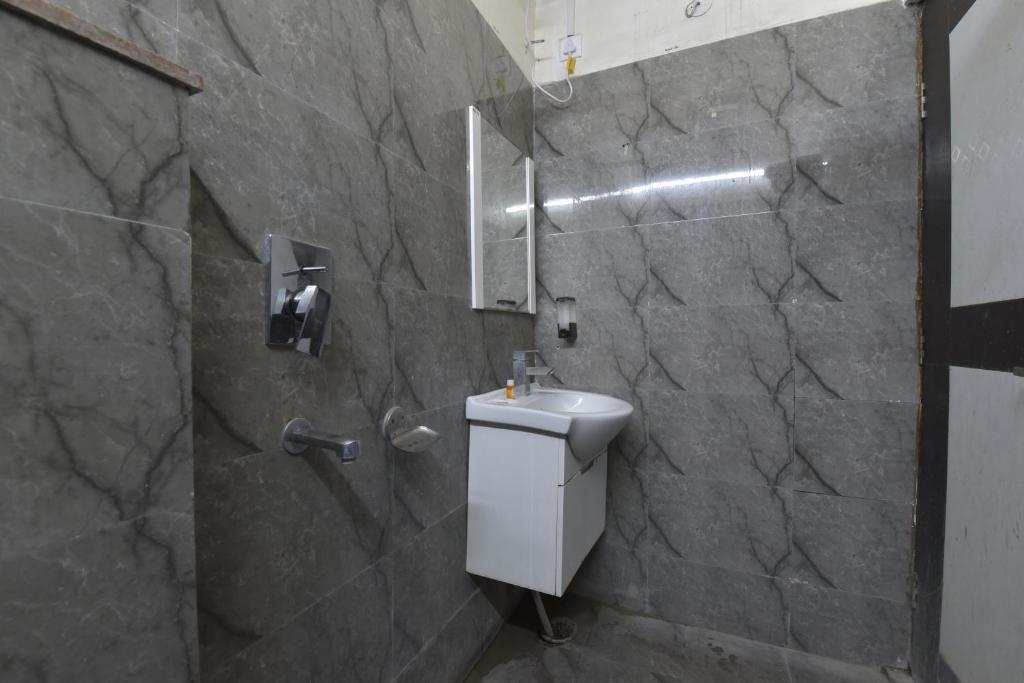 a bathroom with a sink and a shower at Hotel Atyant Shubh in Dehradun