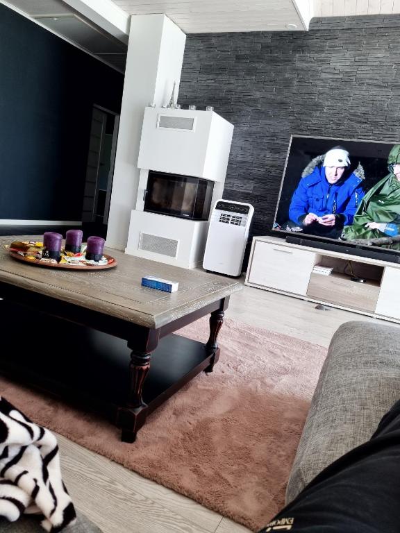 a living room with a coffee table and appliances at Eramaja in Papsaare