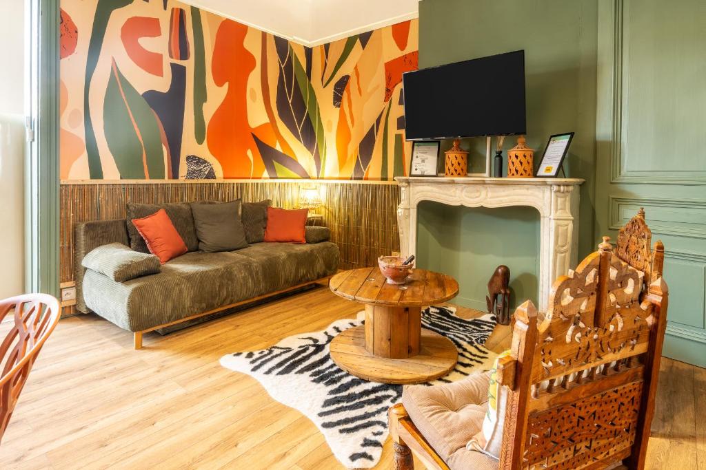 un salon avec un canapé et une cheminée dans l'établissement Sable et savane Proche de la plage, à Dunkerque