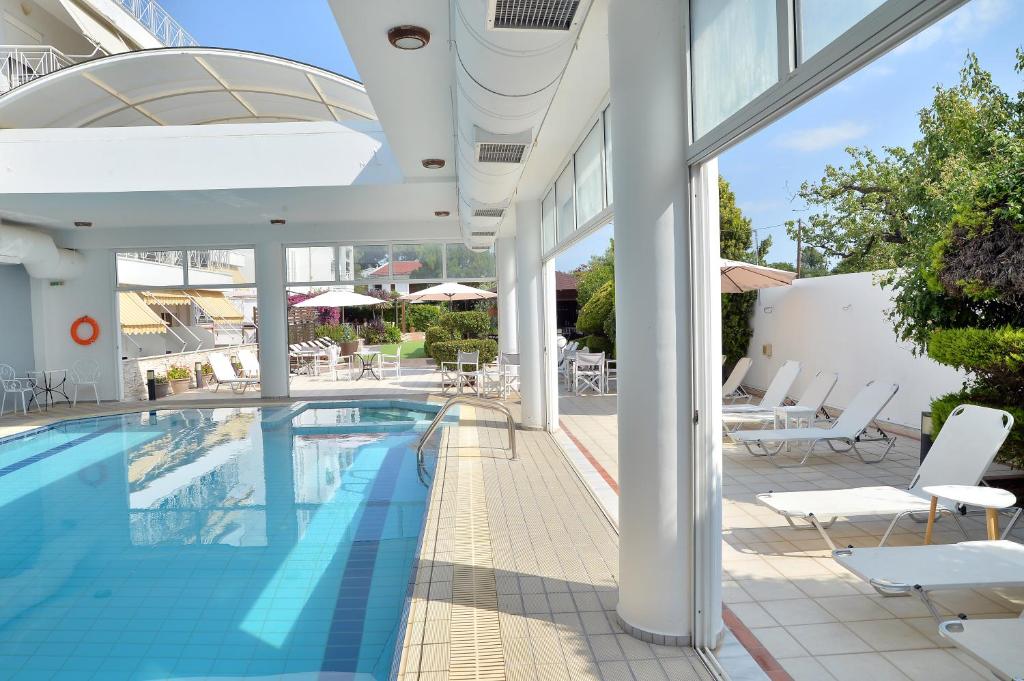 a swimming pool on the side of a building at Hotel Kalloni in Volos