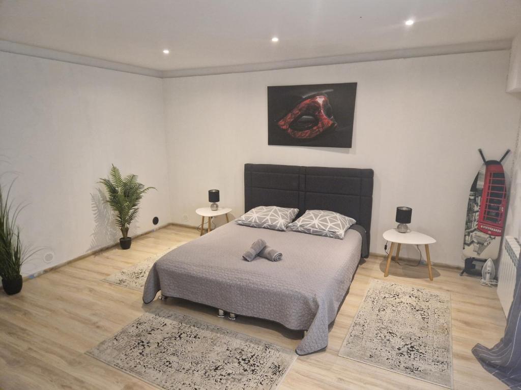a bedroom with a bed and two tables with rugs at Apartament Baza in Przemyśl