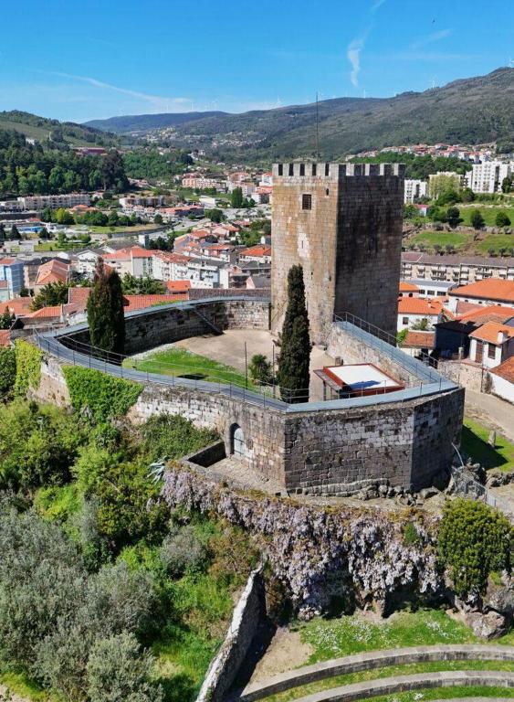 an old stone building with a city in the background at Castelo 48 in Lamego
