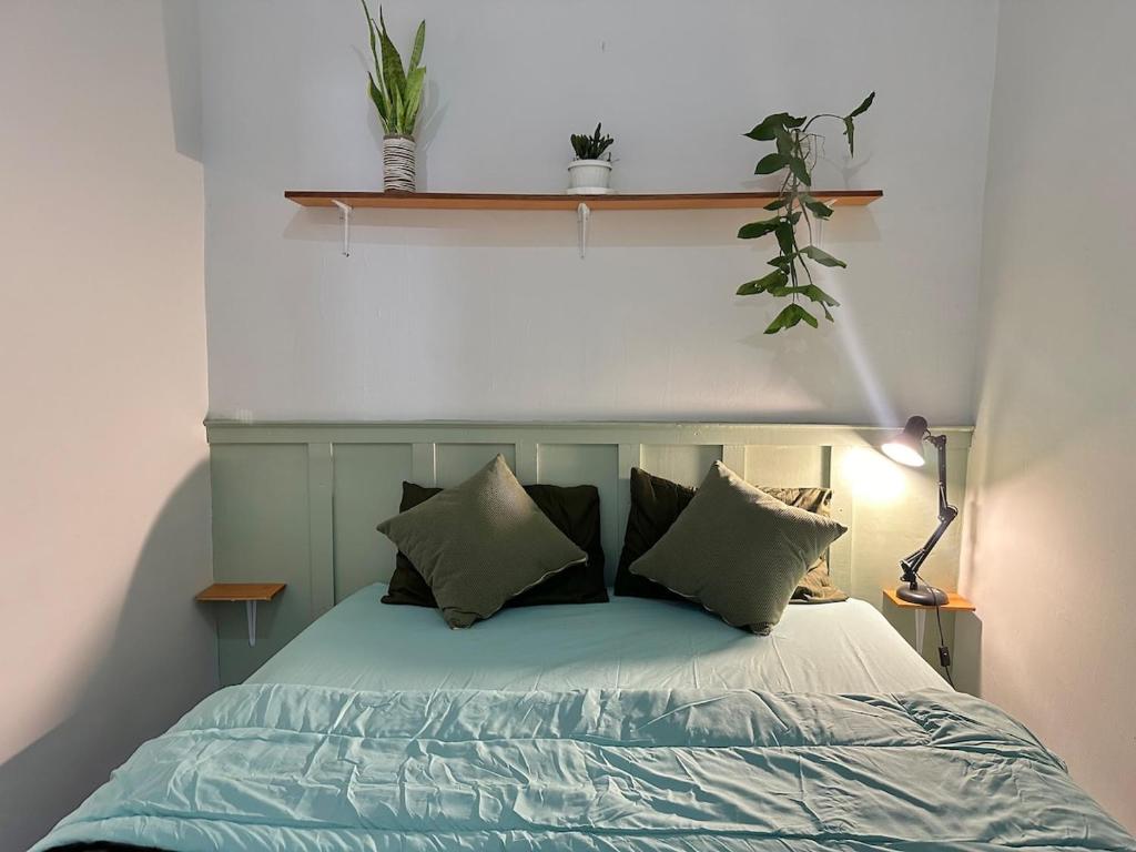 a bedroom with a bed with pillows on it at Slash homestay in Silimapuluh