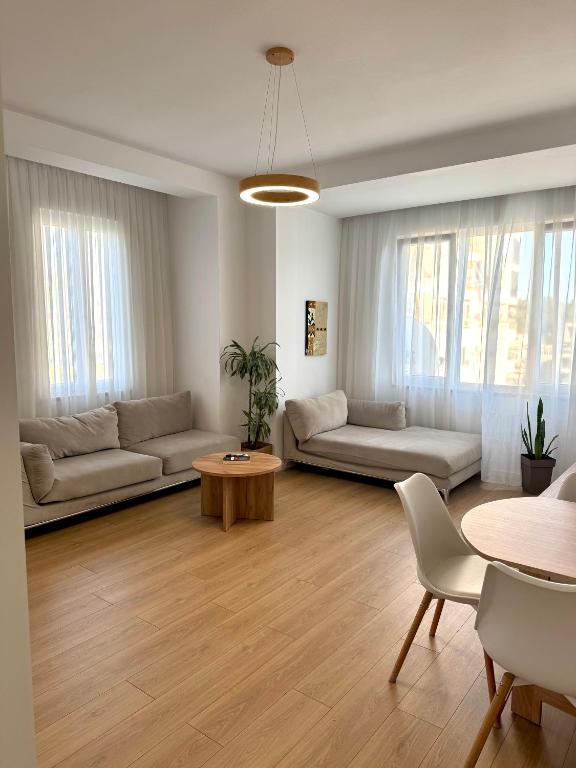 a living room with a couch and a table at Apartment's Aquilo Blloku in Tirana