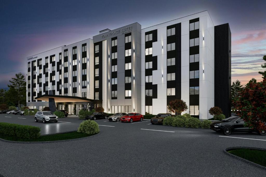 una representación de un edificio con coches estacionados en un estacionamiento en TownePlace Suites by Marriott Chilliwack, en Chilliwack