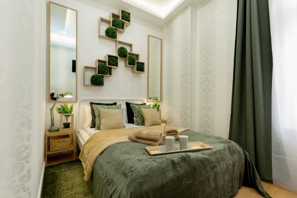 a bedroom with a bed with a tray on it at Stylish Studio Collection Central Budapest in Budapest