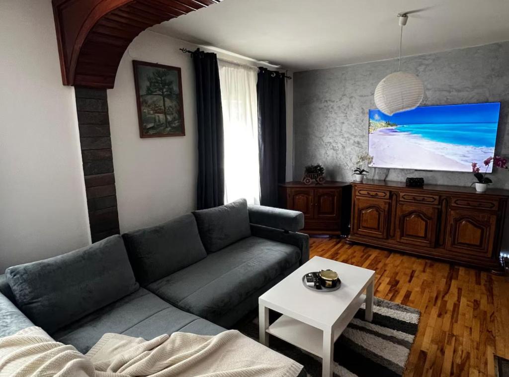 a living room with a couch and a tv at House Burić in Senj