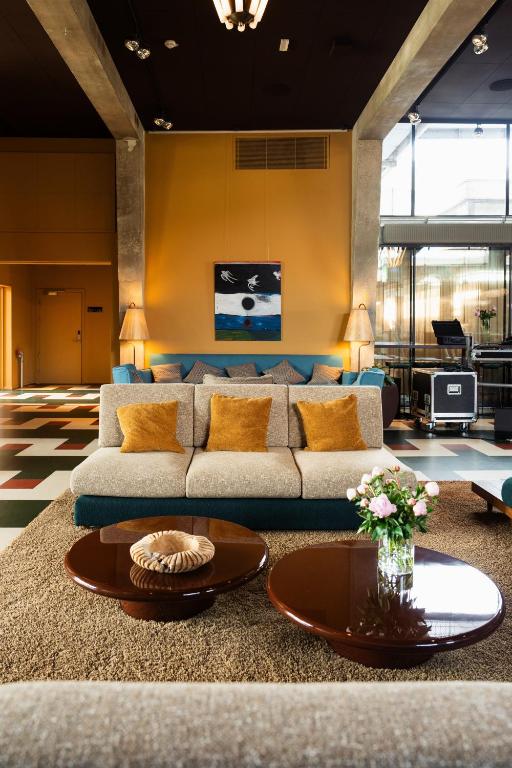 a living room with a couch and a table at Roberta's Society Aarhus in Aarhus