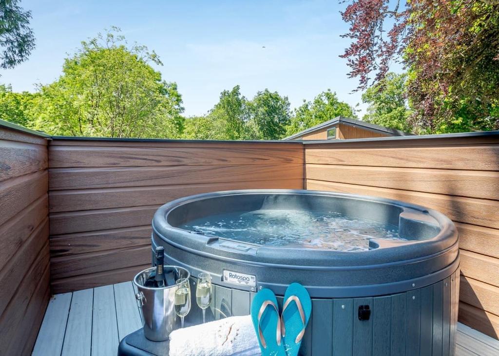 a hot tub on a deck with a wooden fence at V28 - The Lookout with Hot Tub in Bethesda