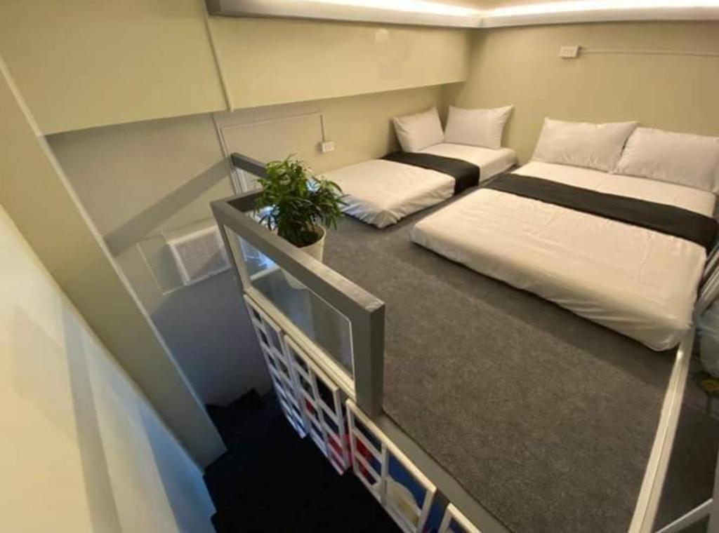 a small room with two beds and a couch at Amaia Steps Altaraza Staycation in Sapang Alat