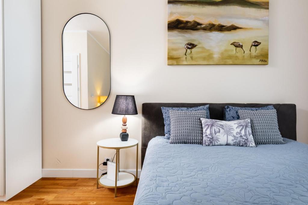 a bedroom with a bed and a mirror at Business Suites Arkadia by VAYA STAYS in Warsaw