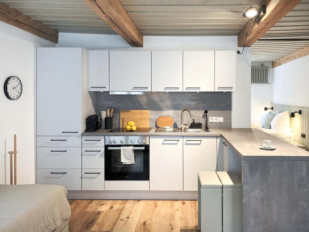 a kitchen with white cabinets and a counter at Ferienwohnung 2, Schlaf-Gut-Johannis, Flensburg in Flensburg